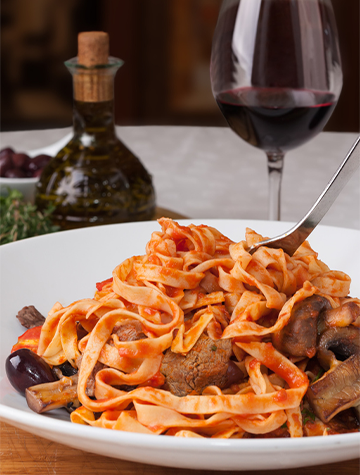 Pasta dish and glass of red wine