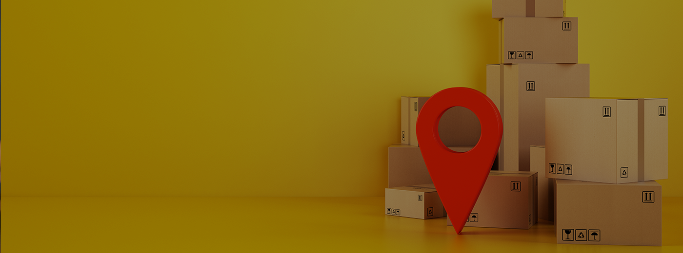 Pile of cardboard boxes on the floor on a yellow background with a red geo tag