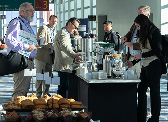 Attendees getting coffee and pastries