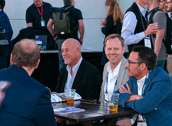 Attendees sitting at a table at the Beer Garden Happy Hour