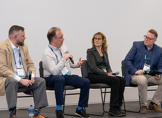 Conference speakers presenting on stage